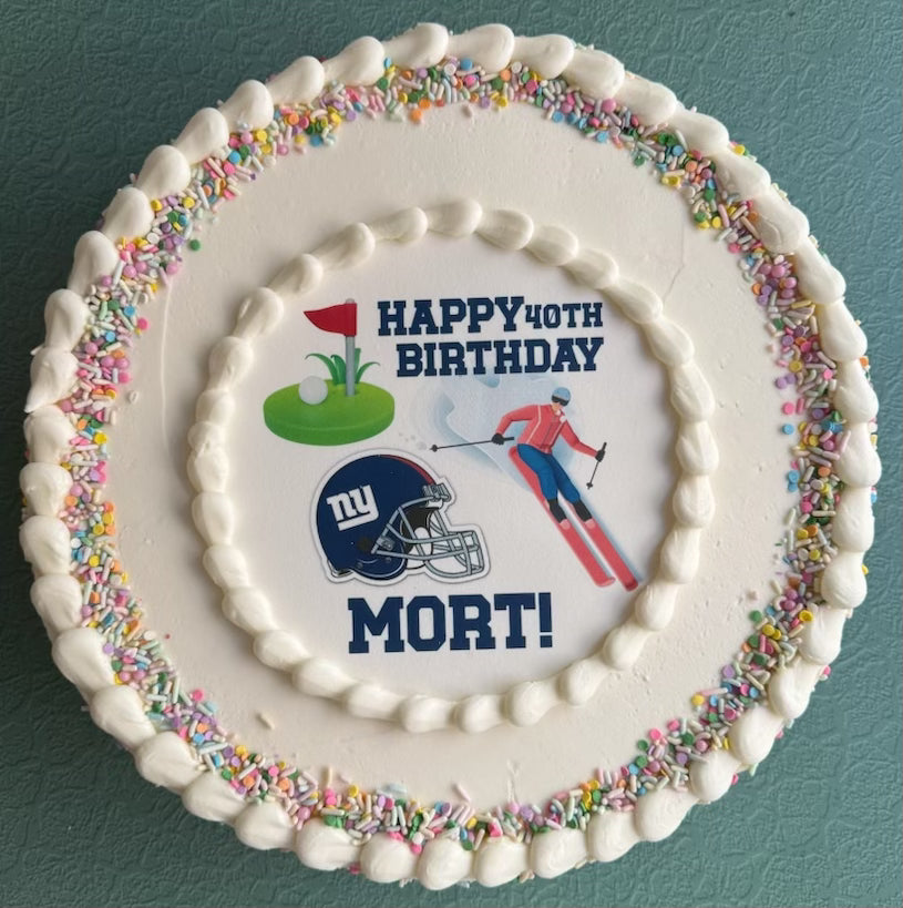Birthday cake with sports-themed decorations and 'Happy 40th Birthday Mort!' text on a blue background.