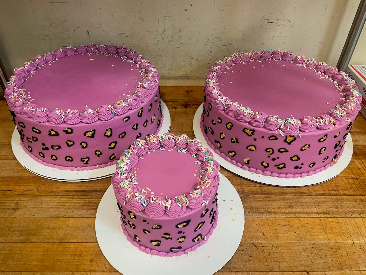A custom decorated cake with green buttercream frosting, featuring a numerical "30", and a name, 'Tim', written on it, indicating a celebration for a 30th anniversary or similar.