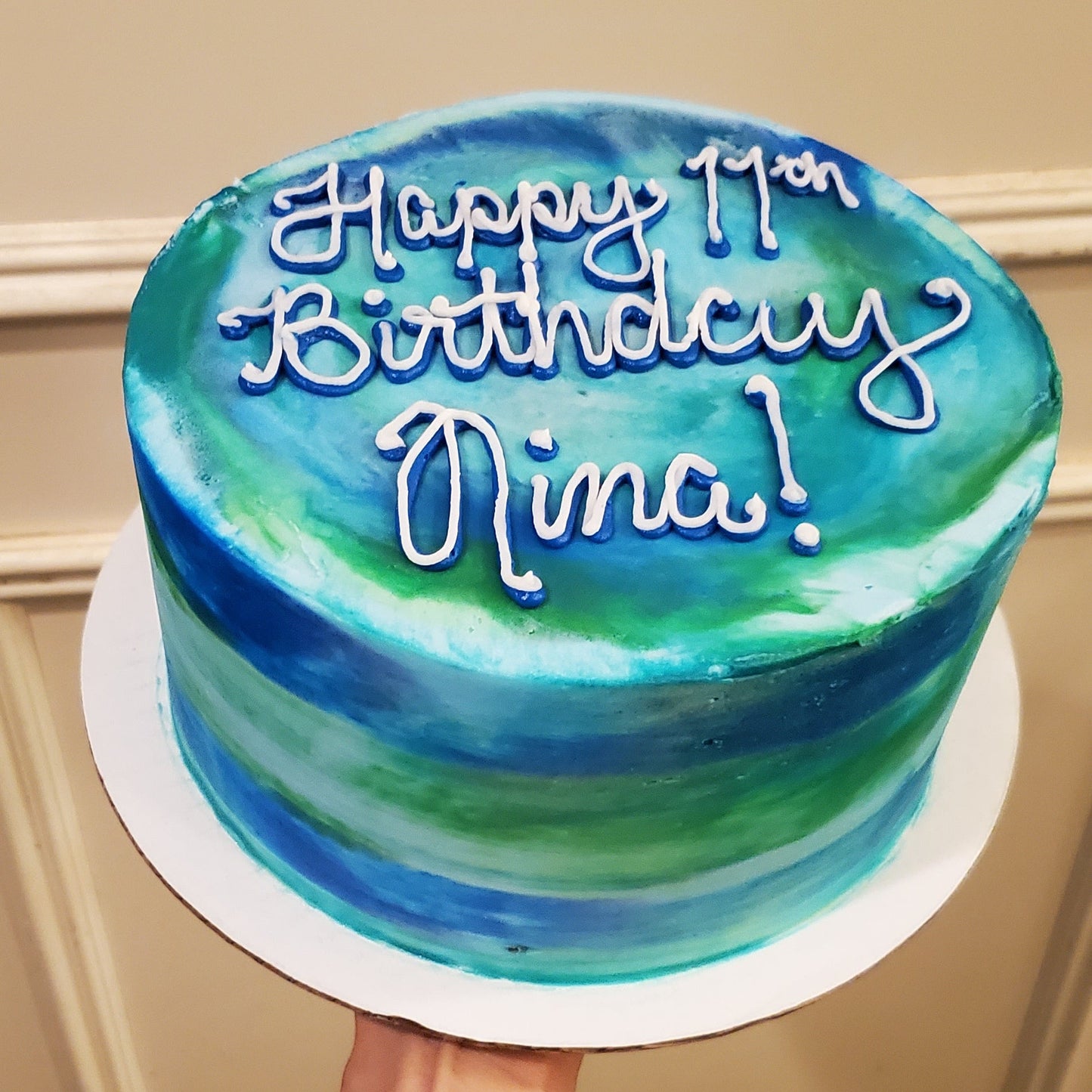 Blue and green birthday cake with 'Happy Birthday' text.